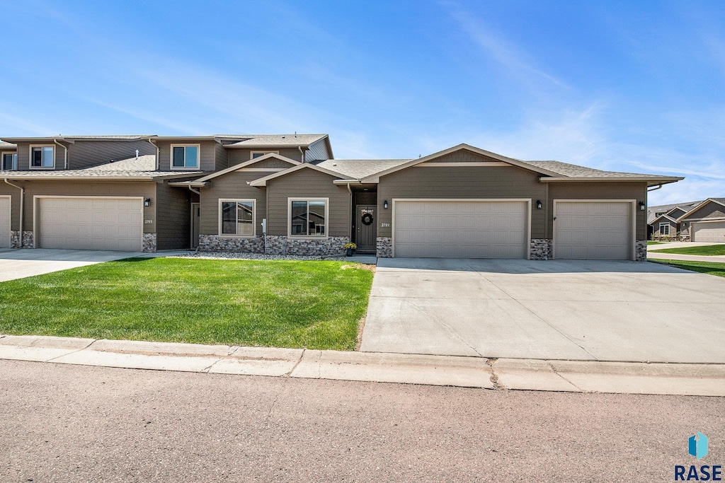 2701 E Meadowside Pl, Sioux Falls, SD 57108 - view of front of property with stone siding, a garage, driveway, and a front yard