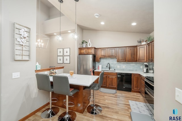 4314 W Shipton St, Sioux Falls, SD 57108 - kitchen featuring stainless steel appliances, a kitchen breakfast bar, light countertops, brown cabinetry, and high vaulted ceiling