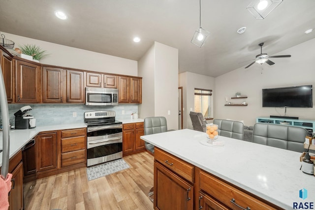 4314 W Shipton St, Sioux Falls, SD 57108 - kitchen featuring stainless steel appliances, light wood-style flooring, open floor plan, light countertops, and ceiling fan