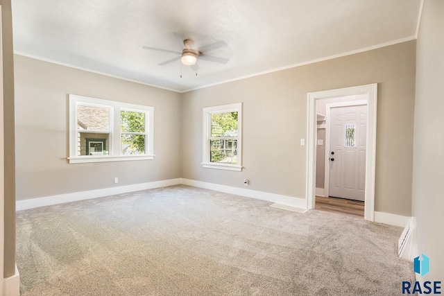 1205 W 14th St, Sioux Falls, SD 57104 - empty room featuring carpet, a ceiling fan, baseboards, and ornamental molding