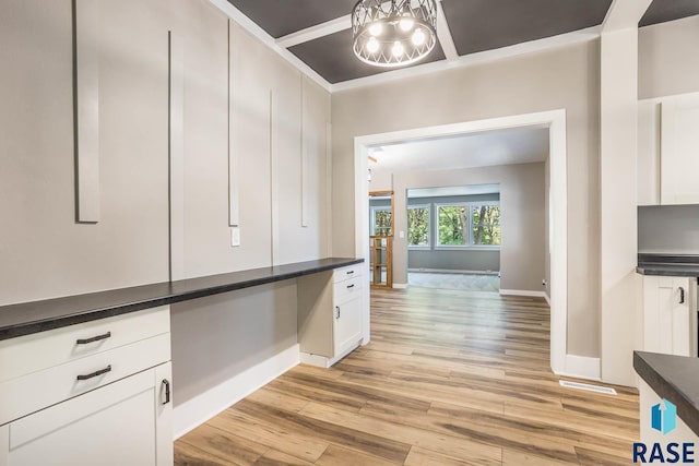 1205 W 14th St, Sioux Falls, SD 57104 - hall with light wood finished floors, baseboards, a chandelier, and a desk