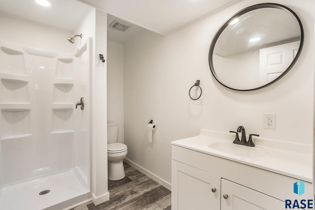 1205 W 14th St, Sioux Falls, SD 57104 - full bathroom featuring toilet, vanity, wood finished floors, a shower, and baseboards