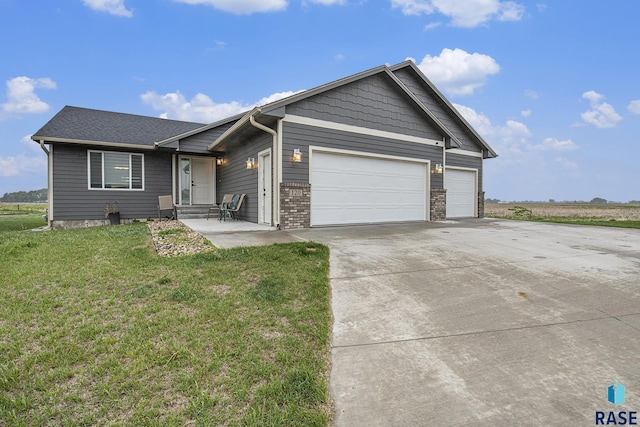120 St Charles Cir, Harrisburg, SD 57032 - view of front of home featuring an attached garage, concrete driveway, and a front yard