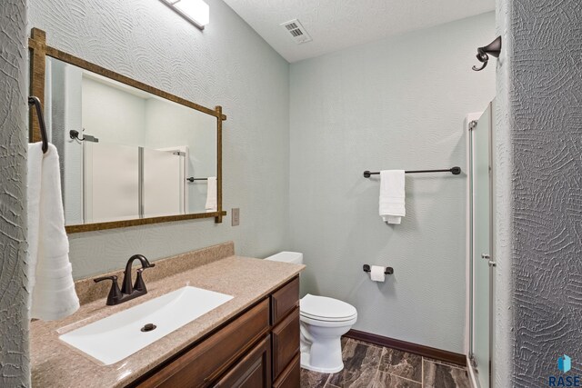 2813 W Stratton Cir, Sioux Falls, SD 57108 - full bathroom featuring a shower stall, vanity, wood finish floors, toilet, and baseboards