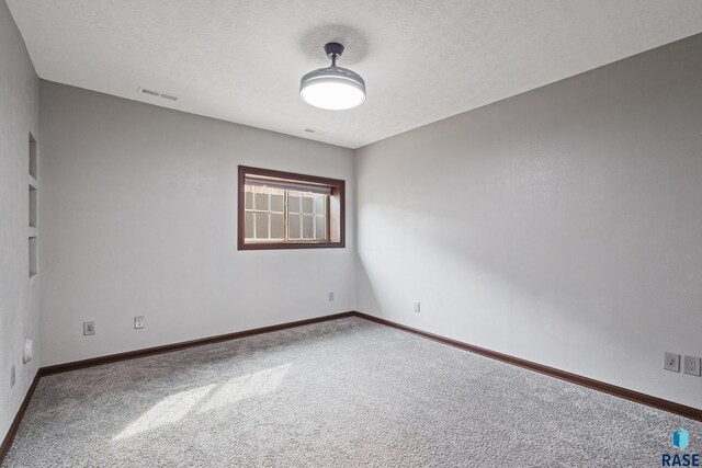 2813 W Stratton Cir, Sioux Falls, SD 57108 - unfurnished room featuring carpet flooring, baseboards, and a textured ceiling