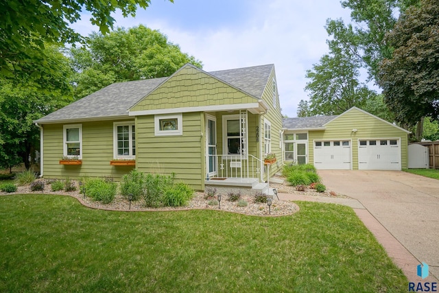 2208 W 22nd St, Sioux Falls, SD 57105 - view of front of house with a shingled roof, a front yard, driveway, and an attached garage