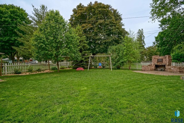 2208 W 22nd St, Sioux Falls, SD 57105 - view of yard featuring an outdoor stone fireplace and a playground