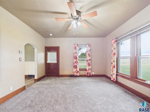 45390 284th St, Hurley, SD 57036 - carpeted spare room featuring arched walkways, ceiling fan, and baseboards