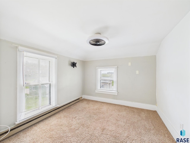 45390 284th St, Hurley, SD 57036 - empty room with a baseboard heating unit, carpet flooring, and baseboards