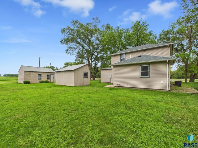 45390 284th St, Hurley, SD 57036 - rear view of property with a yard, central AC, and an outdoor structure