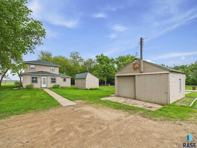 45390 284th St, Hurley, SD 57036 - view of grassy yard featuring an outdoor structure and a detached garage