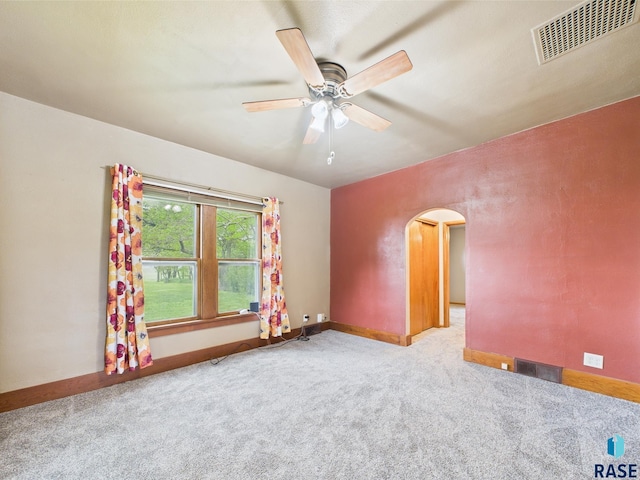 45390 284th St, Hurley, SD 57036 - carpeted empty room featuring arched walkways, ceiling fan, and baseboards