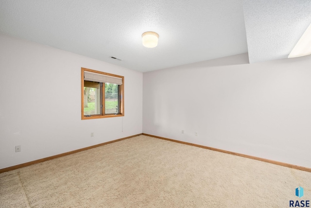 4704 S Pasque Cir, Sioux Falls, SD 57105 - carpeted spare room with a textured ceiling and baseboards