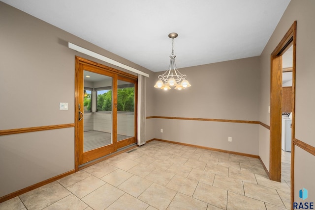 4704 S Pasque Cir, Sioux Falls, SD 57105 - spare room featuring a chandelier, washer / dryer, and baseboards