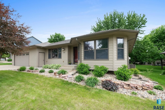 909 E 64th St, Sioux Falls, SD 57108 - ranch-style house featuring a garage, a front yard, and concrete driveway