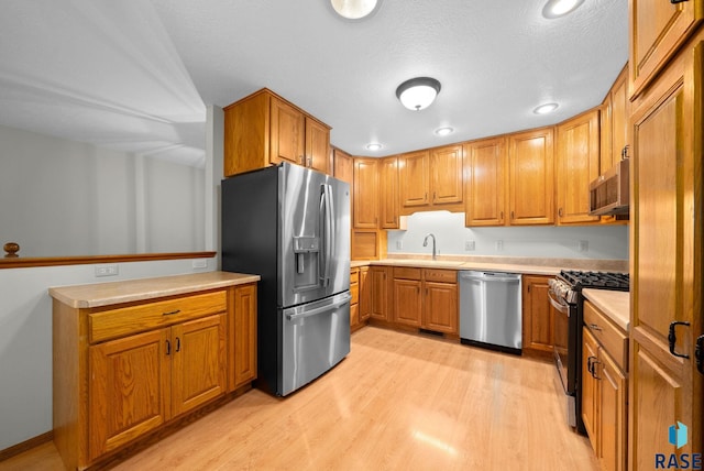 909 E 64th St, Sioux Falls, SD 57108 - kitchen with appliances with stainless steel finishes, light wood-type flooring, brown cabinets, and recessed lighting