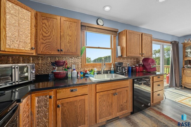 48484 262nd St, Valley Springs, SD 57068 - kitchen featuring a sink, dishwasher, decorative backsplash, wood finished floors, and brown cabinets