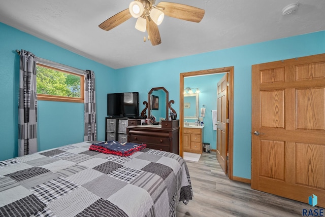 48484 262nd St, Valley Springs, SD 57068 - bedroom with light wood-style floors, ensuite bath, and ceiling fan