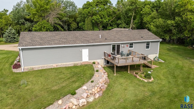 48484 262nd St, Valley Springs, SD 57068 - rear view of house with a wooden deck, roof with shingles, and a yard