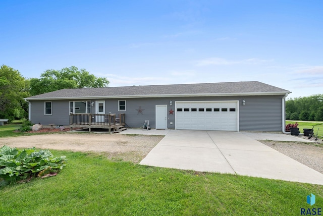 48484 262nd St, Valley Springs, SD 57068 - view of front of house featuring an attached garage, a front lawn, a deck, and concrete driveway