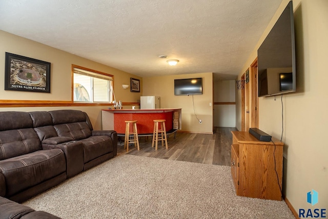 4436 W Briggs Dr, Sioux Falls, SD 57107 - living area with wood finished floors, a textured ceiling, and baseboards