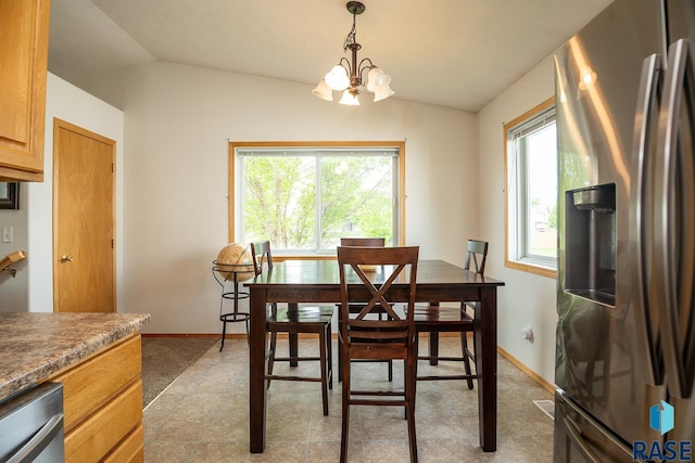 4436 W Briggs Dr, Sioux Falls, SD 57107 - dining space with lofted ceiling, a chandelier, baseboards, and light floors