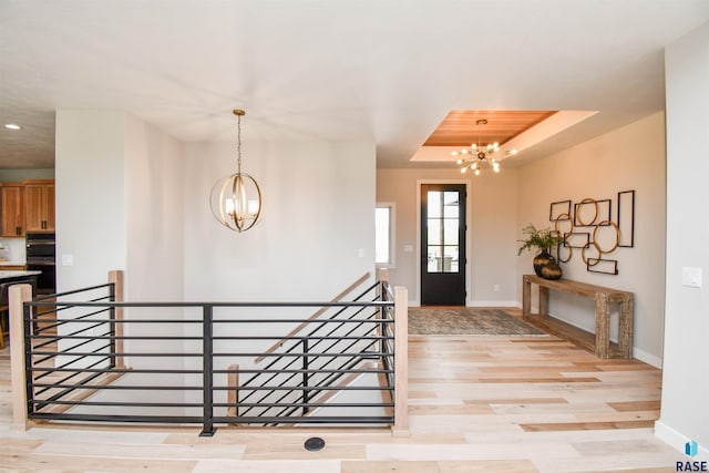 6504 E Hawker Trl, Sioux Falls, SD 57110 - foyer entrance with a chandelier, baseboards, light wood finished floors, recessed lighting, and a raised ceiling