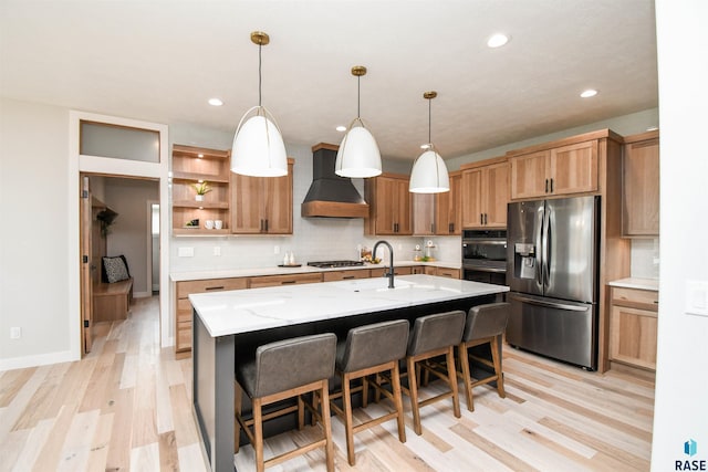 6504 E Hawker Trl, Sioux Falls, SD 57110 - kitchen featuring appliances with stainless steel finishes, wall chimney exhaust hood, light wood-style floors, open shelves, and a sink