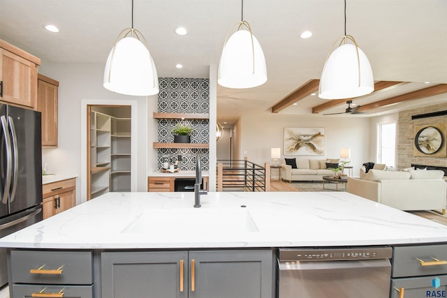 6504 E Hawker Trl, Sioux Falls, SD 57110 - kitchen with gray cabinets, appliances with stainless steel finishes, a sink, recessed lighting, and beam ceiling