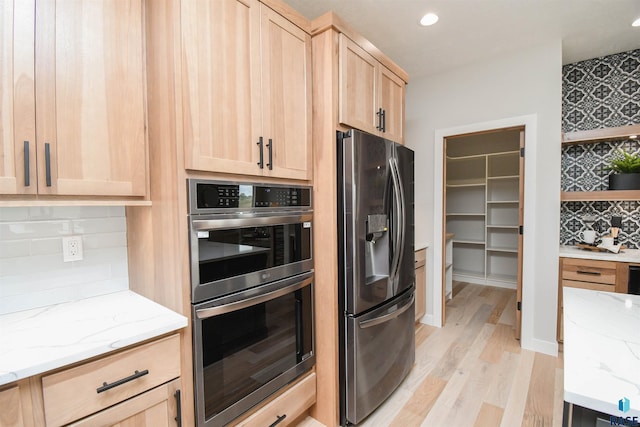 6504 E Hawker Trl, Sioux Falls, SD 57110 - kitchen with stainless steel appliances, light brown cabinetry, light wood-style floors, light stone countertops, and recessed lighting