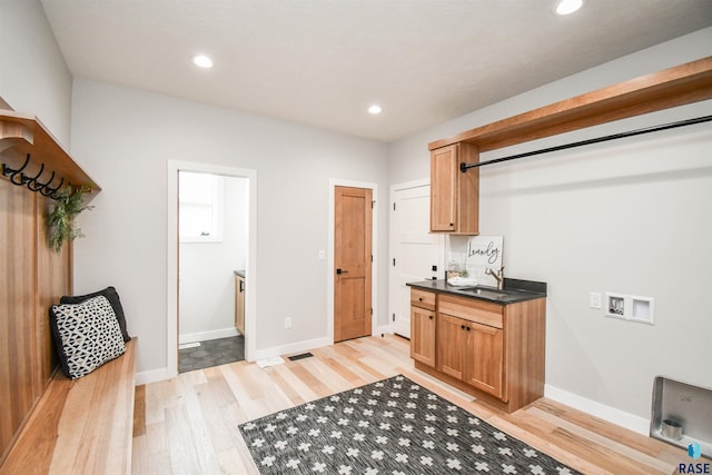 6504 E Hawker Trl, Sioux Falls, SD 57110 - laundry room with light wood finished floors, washer hookup, recessed lighting, cabinet space, and baseboards