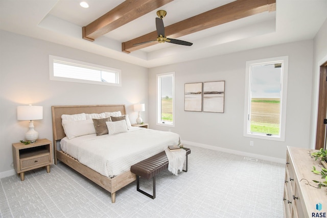 6504 E Hawker Trl, Sioux Falls, SD 57110 - bedroom with multiple windows, baseboards, beam ceiling, light colored carpet, and ceiling fan