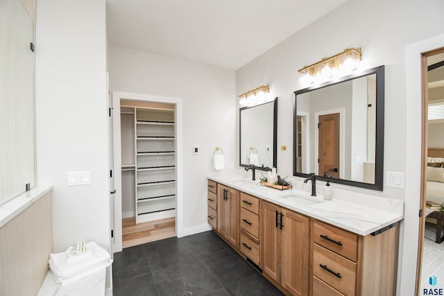 6504 E Hawker Trl, Sioux Falls, SD 57110 - full bath featuring double vanity, a spacious closet, ensuite bathroom, and tile patterned flooring