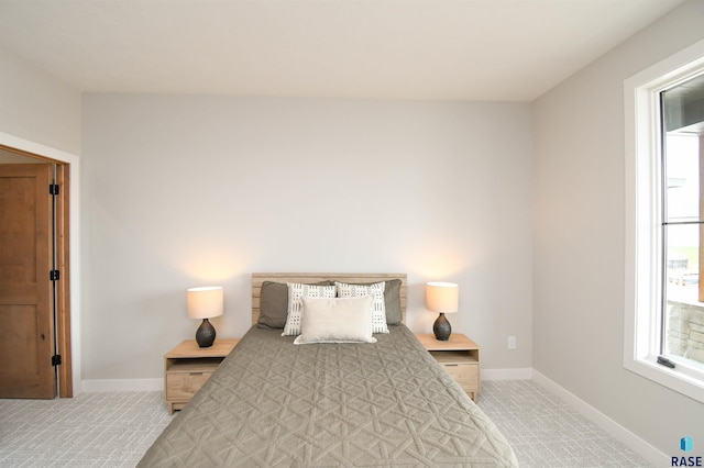 6504 E Hawker Trl, Sioux Falls, SD 57110 - bedroom with multiple windows, baseboards, and light colored carpet