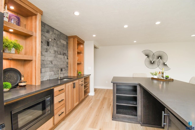 6504 E Hawker Trl, Sioux Falls, SD 57110 - bar area with a sink, light wood-style flooring, recessed lighting, black microwave, and baseboards