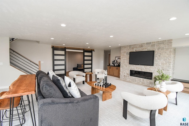 6504 E Hawker Trl, Sioux Falls, SD 57110 - living area featuring a barn door, recessed lighting, a stone fireplace, and stairway