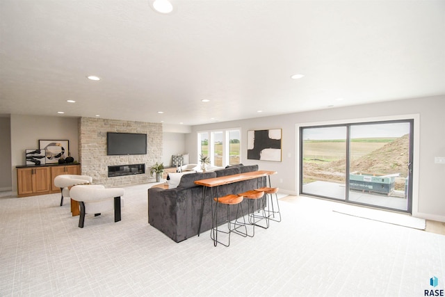 6504 E Hawker Trl, Sioux Falls, SD 57110 - living area with recessed lighting, baseboards, light carpet, and a stone fireplace
