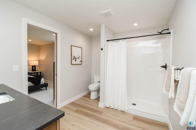 6504 E Hawker Trl, Sioux Falls, SD 57110 - full bath with vanity, wood finished floors, toilet, a shower with shower curtain, and recessed lighting
