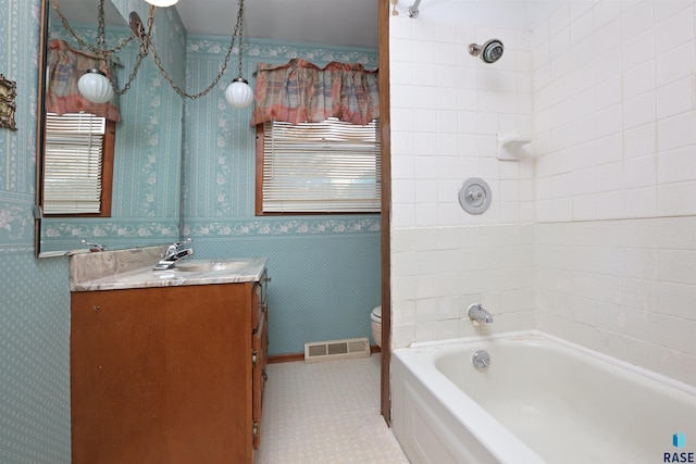 6905 W 6th St, Sioux Falls, SD 57107 - full bath with vanity, toilet, wallpapered walls, and tub / shower combination