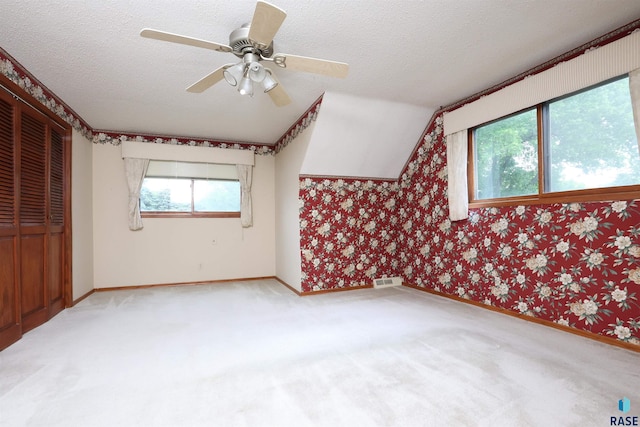 6905 W 6th St, Sioux Falls, SD 57107 - unfurnished bedroom with carpet, baseboards, a textured ceiling, a closet, and ceiling fan