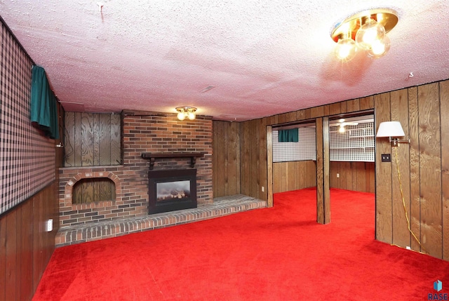 6905 W 6th St, Sioux Falls, SD 57107 - unfurnished living room featuring carpet floors, wooden walls, a fireplace, and a textured ceiling