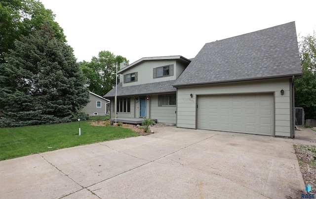 6905 W 6th St, Sioux Falls, SD 57107 - traditional home with roof with shingles, driveway, a front lawn, an attached garage, and a porch