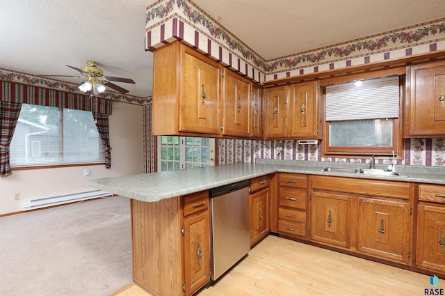 6905 W 6th St, Sioux Falls, SD 57107 - kitchen with stainless steel dishwasher, a sink, a baseboard heating unit, brown cabinets, and a textured ceiling