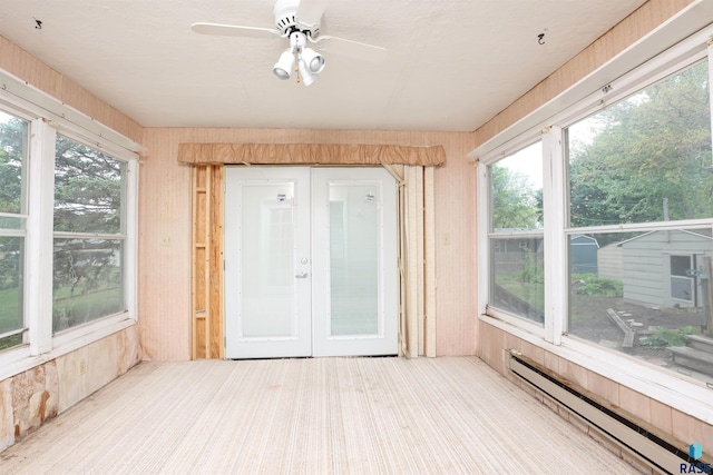 6905 W 6th St, Sioux Falls, SD 57107 - unfurnished sunroom featuring a baseboard heating unit, a ceiling fan, french doors, wooden walls, and carpet flooring
