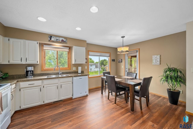 4401 E 28th St, Sioux Falls, SD 57103 - kitchen featuring white appliances, a sink, dark wood-style flooring, white cabinets, and baseboards