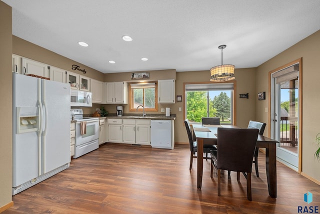 4401 E 28th St, Sioux Falls, SD 57103 - kitchen featuring white appliances, a sink, white cabinets, recessed lighting, and dark wood-style floors