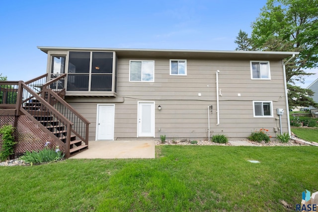 4401 E 28th St, Sioux Falls, SD 57103 - back of property with a patio, stairs, a sunroom, and a yard