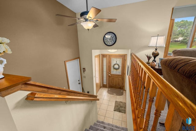 4401 E 28th St, Sioux Falls, SD 57103 - foyer featuring light tile patterned floors, ceiling fan, stairway, and high vaulted ceiling