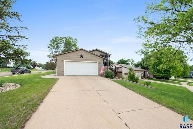 4401 E 28th St, Sioux Falls, SD 57103 - view of front of home with a front lawn, a garage, and driveway