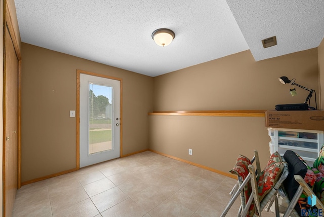 4401 E 28th St, Sioux Falls, SD 57103 - entryway with a textured ceiling, baseboards, and light tile patterned flooring